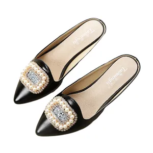 Elegant pointed-toe flat mule with pearl and rhinestone square buckle in black matte finish