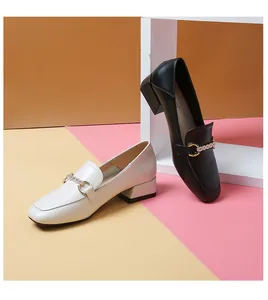 Detail of square toe loafer featuring sparkling rhinestone metal buckle and block heel