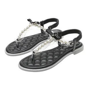 Women's flat flip-flop sandals with white pearls, black bow, and diamond accents