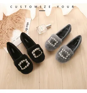 Detailed top view of plush loafer shoes featuring square pearl rhinestone buckles