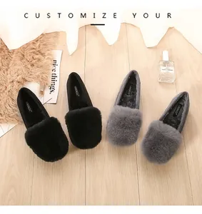 Detail view of stylish women's loafers with fluffy rabbit fur in black and grey colors