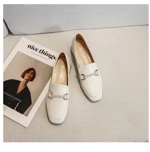Top view of beige square toe loafers featuring a sparkling crystal chain link detail