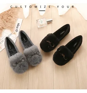 Close-up of winter faux fur loafers with decorative bowknot metal detail and warm lining