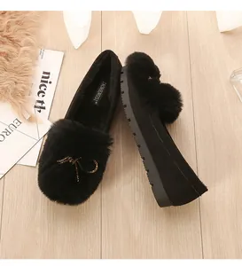Detailed top view of black faux fur loafers with bow and non-slip rubber platform sole