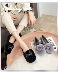 Detail of plush loafer shoes with ribbon bows and cozy warm faux fur lining