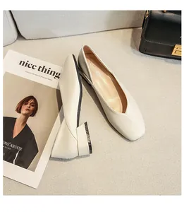 Detailed view of cream square toe block heel pumps with elegant V-cut and leather texture