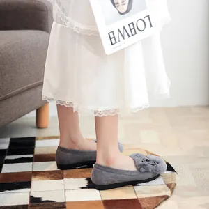Women's grey faux suede loafers with thick fur trim and metal buckle detail