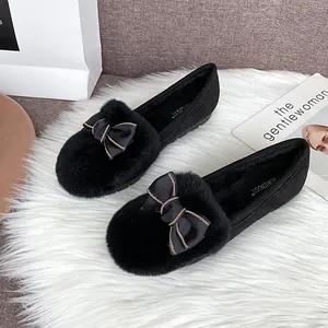 Plush black platform loafers for women featuring a golden chain bow and warm fur lining