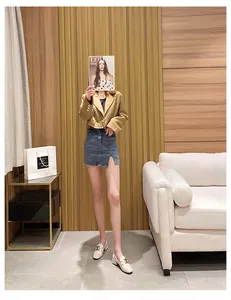 Close-up of cream chunky loafer shoes with gold horsebit buckle and khaki blazer outfit