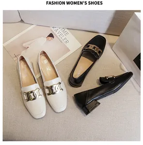 Detail of square toe loafers with gold chain links in black and beige matte leather