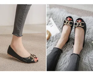 Detailed view of black peep-toe flats with chunky gold chain buckle and non-slip sole