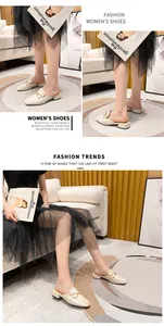 Detailed close-up of beige square-toe mule featuring a gold buckle and mid-block heel
