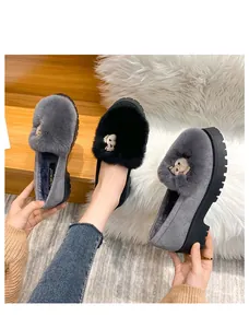 Detailed close-up of thick platform plush loafers with warm fur lining and metal fox buckles
