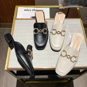 Women's pointed-toe loafer mules with rhinestone horsebit buckle in black and beige