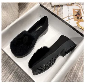 Detailansicht schwarzer Kunstfell-Loafer mit dicken Sohlen in einer Geschenkbox