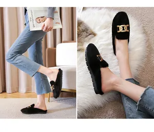 Detail of black faux fur mules with gold chain links and non-slip rubber sole