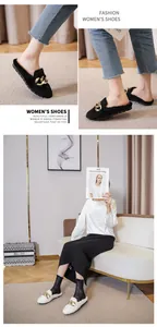 Detailed view of women's faux fur mule slippers with gold chain accent and soft fleece lining