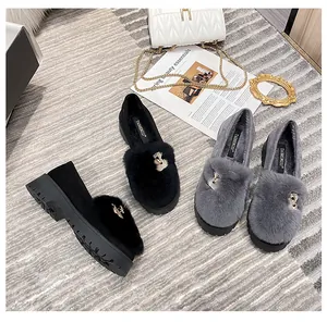 Detail view of winter plush loafers with gold crown buckles and thick non-slip soles