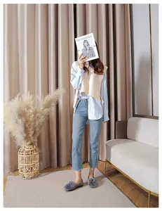 Chic grey faux fur loafers paired with blue jeans and beige vest for autumn fashion