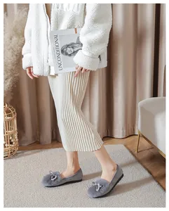Dettaglio di ballerine grigie con pelliccia sintetica e fiocco elegante con perle