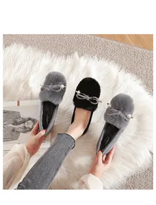 Detail view of winter plush loafer with faux fur trim and pearl bow buckle detail