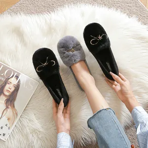 Faux rabbit fur loafers with gold chain bow detail in black and grey colors
