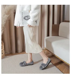 Detail of grey winter loafers with faux fur lining and pearl metal buckle on the vamp