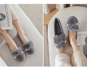 Detail view of gray plush loafers with pearl accents and fur lining for winter comfort