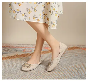 Eleganti ballerine in jacquard beige con fibbie quadrate in strass su tappeto etnico