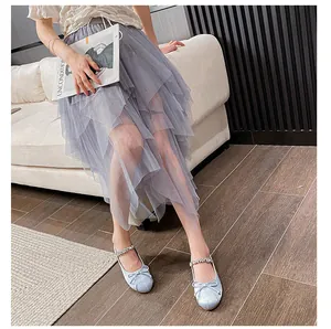 Detail of light blue Mary Jane flats with bow and rhinestones paired with tulle skirt