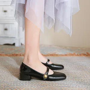 French vintage black patent leather Mary Jane shoes with low block heels and gold buttons
