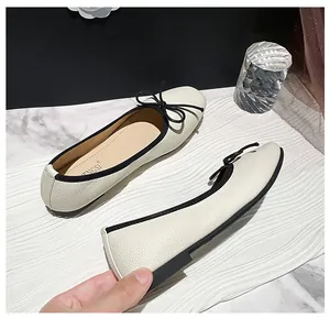 Detail showing the flexible leather sole and soft bow accent of these ballet flats