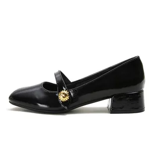 Classic black patent leather Mary Jane shoes with round toe and gold flower buckle