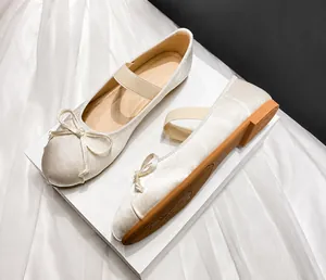 Close-up of silk satin Mary Jane flats with bow detail and premium rubber sole