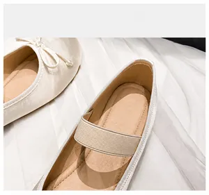 Close-up of breathable microfiber inner lining and soft bow on silk satin ballet flats
