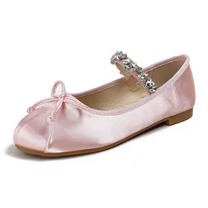 Pink satin ballet flats for girls with rhinestone strap and delicate bow detail