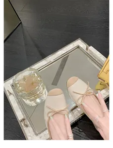 Dettaglio ravvicinato di ballerine stile francese con fiocco e punta quadrata bicolore