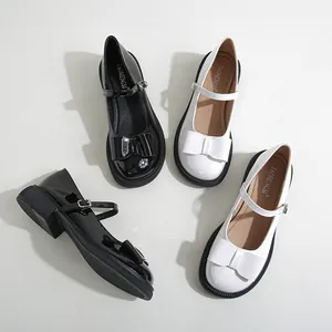 Glossy patent leather Mary Jane shoes with bow detail and chunky platform soles