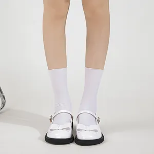 White glossy Mary Jane shoes with ribbon bow and chunky black platform sole