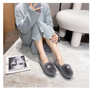 Detail of grey plush faux fur flat shoe with elegant pearl and rhinestone flower decor