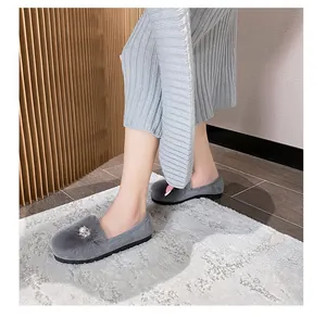 Detail of grey faux fur flat shoes with pearl and rhinestone buckle decoration