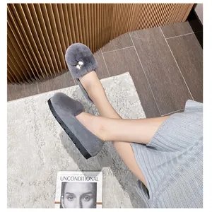 Gray plush loafers with faux fur trim and pearl bow buckle on non-slip rubber soles