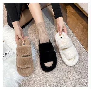 Three colors of warm faux fur platform slippers displayed in a cozy home setting
