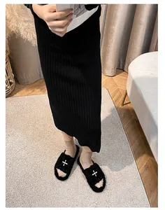 Detail of plush black slippers with white star pattern and thick soles for autumn wear