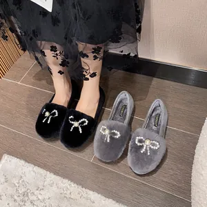 Plush faux fur platform shoes with pearl bow decoration in black and grey colors