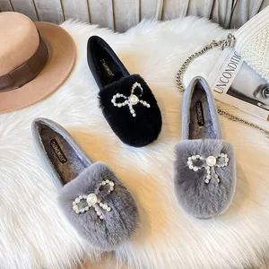 Plush faux fur ballet flats with pearl bow and warm lining in black and gray tones