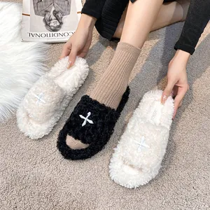 Plush cross-stitch faux fur open-toe platform slides in black and off-white