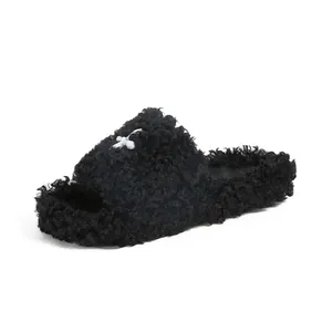 Fleece flat slippers in black faux fur with a white cross design for women's outdoor wear