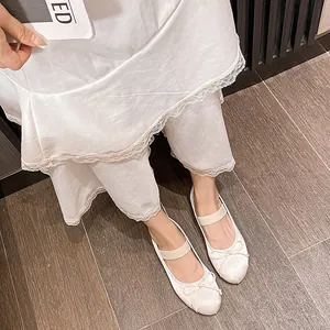 French vintage ballet flats in pearl white with bow tie and elastic strap detail