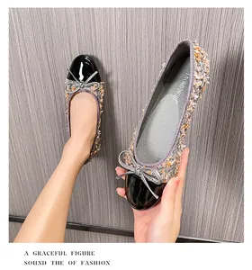 Detail of tweed ballet flats with black patent leather toe and silver bow accent